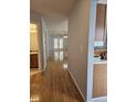 Hallway with hardwood floors leads to a bright living space and bathroom at 103 Dupont Way, Summerville, SC 29485