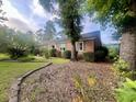Spacious brick home surrounded by mature trees, offering a serene and private setting on a well-manicured lot at 104 Silverhill Rd, Walterboro, SC 29488