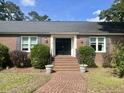 Classic brick home with an inviting brick walkway and manicured shrubs leading to a double door entryway at 104 Silverhill Rd, Walterboro, SC 29488