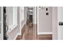 Bright hallway with glossy wood floors leading to a living space with a fireplace at 110 Instructor Ct, Ladson, SC 29456