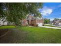 Charming two-story brick home featuring an attached two car garage and a well-manicured lawn at 116 Holbrook Ln, Goose Creek, SC 29445