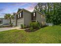 Beautiful two-story townhouse featuring a lush green lawn, perfect for relaxing and enjoying the outdoors at 124 Bright Meadow Rd, Summerville, SC 29483