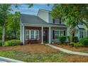 Attractive townhome facade with tidy landscaping, a cozy bench, and coordinated exterior colors at 1304 Elm Hall Cir, Summerville, SC 29483