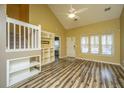 Bright living room boasting high ceilings, wood floors, and a unique built-in shelving unit at 1304 Elm Hall Cir, Summerville, SC 29483