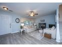 Open-concept living room featuring wood floors, comfortable seating, and a cozy atmosphere at 1401 Elm Hall Cir, Summerville, SC 29483