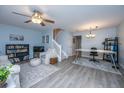 Bright living room with wood floors, modern furniture and decor with a staircase in view at 1401 Elm Hall Cir, Summerville, SC 29483