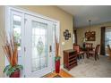 Warm and inviting foyer featuring a decorative glass front door and elegant dining area at 1409 Bloomingdale Ln, Mount Pleasant, SC 29466