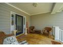 Comfortable front porch with wicker seating, decorative plants, and a stylish front door at 1409 Bloomingdale Ln, Mount Pleasant, SC 29466