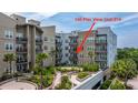 Beautiful building with multiple balconies, a landscaped garden, and unique architectural elements at 145 Pier View St # 214, Daniel Island, SC 29492