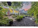 Secluded backyard oasis with lush greenery, manicured shrubs, and an inviting patio setup at 148 Longdale Dr, Summerville, SC 29483