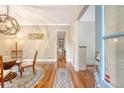 Elegant dining room with hardwood floors, stylish light fixture, and a view through to a bright, well-lit space at 183 Civitas St, Mount Pleasant, SC 29464
