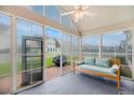 Bright sunroom with a comfortable seating area and large windows offering scenic backyard views at 193 Cypress Forest Dr, Moncks Corner, SC 29461