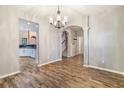 Dining room with hardwood flooring, chandelier lighting, and arched entryway at 2005 Isabela Ct, Summerville, SC 29483