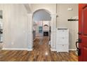 Welcoming foyer with wood floors, an arched doorway and shoe cabinet at 2005 Isabela Ct, Summerville, SC 29483