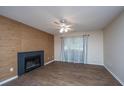 Living room with fireplace, wood-look floors, and a ceiling fan at 2011 N Highway 17 # 1400B, Mount Pleasant, SC 29466