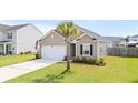 Charming single Gathering home featuring an attached garage, manicured lawn, and beautiful palm tree at 215 Cypress Plantation Rd, Moncks Corner, SC 29461