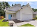 Well-maintained single-Gathering home featuring a bright blue door, two-car garage, and landscaped front at 252 Island Green Rd, Goose Creek, SC 29445