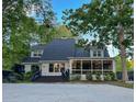 Spacious backyard featuring a patio area, lush greenery, and a screened-in porch, perfect for outdoor living at 27 Fitzroy Dr, Charleston, SC 29414
