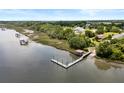 Drone shot showing a home's private boat dock, boat ramp and river access surrounded by lush greenery at 2962 Anchor Watch Dr, Wadmalaw Island, SC 29487