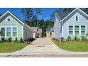 Street view of colorful cottage-style homes with lush landscaping and a shared driveways at 326 Trailmore Ln, Summerville, SC 29486