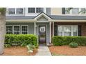 Attractive townhouse with a well-manicured lawn, verdant bushes, and inviting entryway at 402 Pine Bluff Dr, Summerville, SC 29483