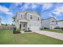 Charming two-story home with a well-manicured lawn, two-car garage, and welcoming front porch at 452 Minim St, Charleston, SC 29414