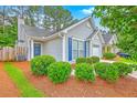 This charming home is complemented by well-maintained landscaping, featuring lush bushes and a vibrant green lawn at 4831 Carnoustie Ct, Summerville, SC 29485