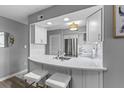 Eat-in kitchen featuring white cabinetry, marble countertop and stainless steel appliances at 55 Ashley Ave # 6, Charleston, SC 29401