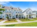 Street view of attractive townhomes with inviting front porches and well-manicured landscaping at 557 Blueway Ave, Summerville, SC 29486