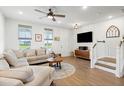 Cozy living room features a comfortable sectional sofa, wood flooring, and ample natural light at 557 Blueway Ave, Summerville, SC 29486