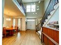 Bright foyer featuring a hardwood floor, chandelier, staircase, and a double-door entry at 6212 Fieldstone Cir, Charleston, SC 29414