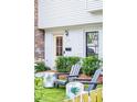 Home featuring inviting Adirondack chairs and lush green landscaping at 705 Williamson Dr # C, Mount Pleasant, SC 29464