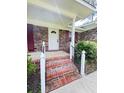 Inviting front entrance featuring brick steps and a freshly painted front door with red shutters at 710 Gadsden Loop, Walterboro, SC 29488