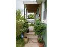 Inviting front porch with potted plants and charming details at 716 White Oak Dr, Charleston, SC 29407