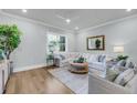 Cozy living room with a large window, comfortable seating, and elegant interior design at 7413 Indigo Palms Way, Johns Island, SC 29455
