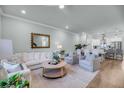 Inviting living room with white sofa and chairs, stylish decor, and an open concept design at 7413 Indigo Palms Way, Johns Island, SC 29455