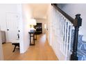 Bright foyer featuring hardwood floors, staircase with patterned runner and black handrail, and elegant decor at 760 Natchez Circle Cir, Mount Pleasant, SC 29464