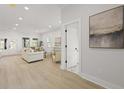 Bright, open-concept living area features shiplap walls and light hardwood flooring at 868 Tripe St, Charleston, SC 29407