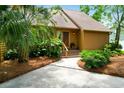 Charming home features a wooden porch, lush landscaping, and a well-manicured lawn at 919 Overview Ct, Mount Pleasant, SC 29464