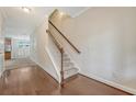 Bright foyer features hardwood floors with staircase and view of the kitchen at 9646 Scarborough Ct, Summerville, SC 29485