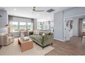 Spacious living room with large windows, comfortable seating, and open floor plan to kitchen at 104 Orchard Blossom Ln, Summerville, SC 29485