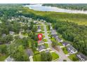 Serene neighborhood showcasing houses surrounded by lush trees and a beautiful lake in the background at 1042 Steelechase Ln, Hanahan, SC 29410
