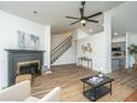 Open-concept living room featuring wood floors, a fireplace, and a view of the adjacent kitchen at 105 Glebe Rd, Summerville, SC 29485