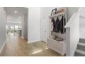 Inviting foyer featuring hardwood floors, a storage bench, and views into the open-concept living space at 122 Lefton Lndg, Summerville, SC 29485