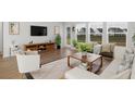 Bright living room with stylish furnishings, large windows, and a sliding glass door at 122 Lefton Lndg, Summerville, SC 29485