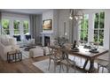 Dining room with fireplace, modern decor, large windows, and plenty of seating at 124 Maritime Way, Summerville, SC 29485