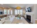 Spacious living room featuring a fireplace, modern decor, and an open floor plan leading to the kitchen at 124 Maritime Way, Summerville, SC 29485