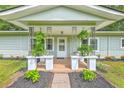 Inviting front porch with stylish columns, greenery, and decorative accents at 1314 Cooper Store Rd, Moncks Corner, SC 29461