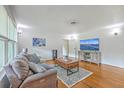 Cozy living room with hardwood floors, comfortable seating, and modern entertainment center at 1314 Cooper Store Rd, Moncks Corner, SC 29461