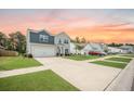 Two-story home featuring blue and gray siding, a spacious driveway, and a well-manicured lawn at 141 Pine Crest View Dr, Summerville, SC 29486